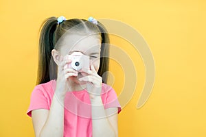 Real happiness. hobby or career. beginner photographer with a camera. childhood. girl takes a picture. kid uses digital camera.