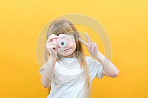 Real happiness. hobby or career. beginner photographer with a camera. childhood. girl takes a picture. kid uses digital camera.