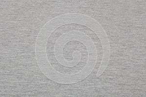 Real heather grey knitted fabric made of synthetic fibres textured background photo
