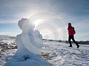 Real icy snowman in winter landscape