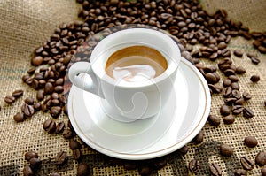 Italian espresso cup near coffee beans on a yute sack photo