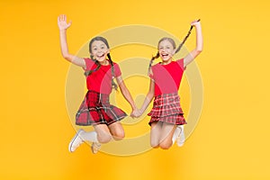 Real joy. happy little girls in checkered skirt. beauty look. happy children on yellow background. childhood happiness