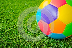 Real leather Colorful multi colour Soccer ball on green grass .