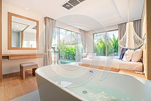 Real Luxury Interior design in bedroom of pool villa with cozy king bed with high raised ceiling home, house ,building