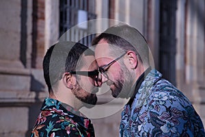 Real marriage portrait of gay couple, hugging, eyes closed and foreheads glued together. Concept lgtb, lgtbiq+, couples, in love,