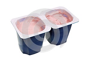 Real nonfat cherry yogurt in blue open plastic cups isolated macro