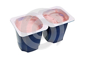 Real nonfat cherry yogurt in blue open plastic cups isolated macro photo