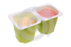 Real nonfat fruits  yogurt in green open plastic cups isolated macro