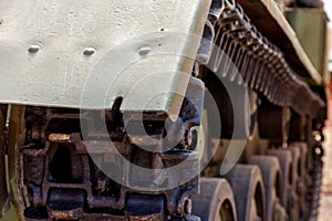 Real old heavy tracked tank and front roller. close up. steampunk detail background