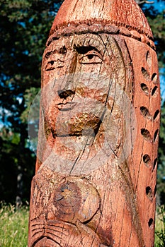 Real pagan altar in the forest with idols in summer light.