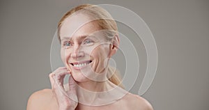 Real people - age, beauty, health and dry skin care concept - beautiful mature Caucasian middle aged woman in her 50s