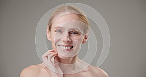 Real people - age, beauty, health and dry skin care concept - beautiful mature Caucasian middle aged woman in her 50s