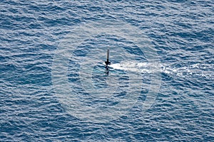 Real periscope and radio transmission mast of the attack submarine  during the submarine sails in the periscope depth in the sea