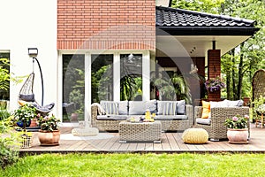 Real photo of a beautiful terrace with garden furniture, plants