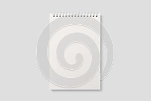 Real photo, blank spiral bound notepad mockup template, isolated on light grey background.