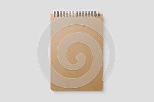 Real photo, blank spiral bound notepad mockup template with Kraft Paper cover, isolated on light grey background.