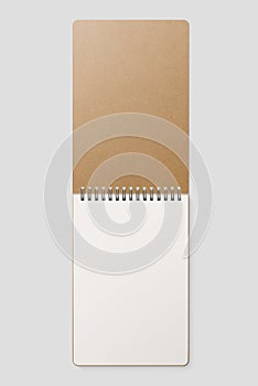 Real photo, blank spiral bound notepad mockup template with Kraft Paper cover, isolated on light grey background.