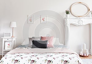 Real photo of bright feminine English style bedroom interior wit