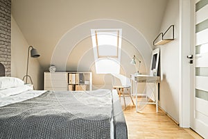 Real photo of bright Nordic style attic room interior with woode