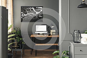 Real photo of dark open space living room interior with map post