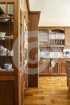 Real photo of a kitchen interior with wooden cupboards and floor photo