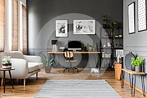 Real photo of open space apartment interior with beige sofa next