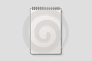 Real photo, spiral bound notepad mockup template with black paper cover, isolated on light grey background.