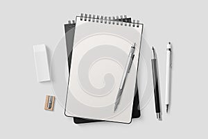 Real photo, spiral bound notepad mockup template with black paper cover, isolated on light grey background.