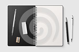 Real photo, spiral bound notepad mockup template with black paper cover, isolated on light grey background.