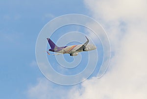 Real plane flying, aircraft, or airplane isolated on blue sky background in travel trip and transportation concept. Flying vehicle