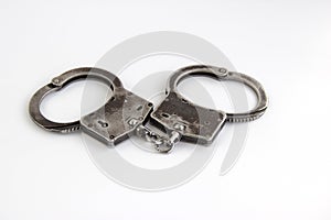 Real police handcuffs isolated on white background