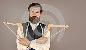 Real professional. professional male sartor with measuring tape and hanger. Handsome man in smart casual wear is holding