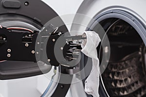 Real robot's hand and washing machine. Concept of Artificial intelligence development and robotic process automation
