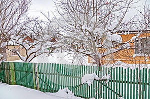 Real Russian winter, when frost and a lot of snow, in the country village, with small houses, roads through snowdrifts