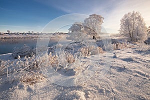 A Real Russian Winter. Morning Frosty Winter Landscape With Dazzling White Snow And Hoarfrost,River And Saturated Blue Sky.
