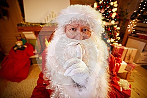 Real Santa Claus gesturing shhh photo