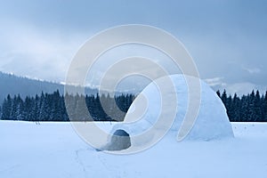 Real snow igloo house in the winter Carpathian mountains photo
