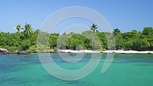Real time shot in idyllic tropical island and beach and turquoise blue water.