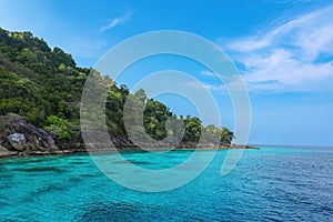 Real tropical green island photo and shallow turquoise sea water color with coral reef underwater in national park travel