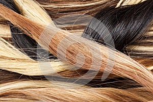 Real woman hair texture. Human hair weft, dry hair with silky volumes. Real european human hair wallpaper texture. Brown