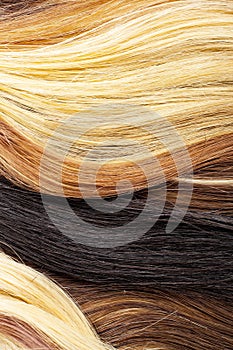 Real woman hair texture. Human hair weft, Dry hair with silky volumes. Real european human hair wallpaper texture. Brown