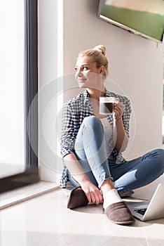 Young woman drinking coffee enjoying relaxing lifestyle