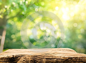 Real wood table top texture on blur leaf tree garden background.For create product display