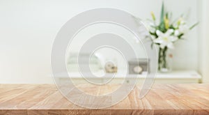 Real wood table top texture on white wall room background.