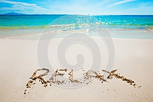 Realax writing on a beach