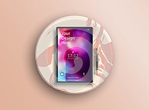 Realistic black tablet with blurry abstract touch screen and pen.Isolated on pink round marble stand. Detailed devices mockup.