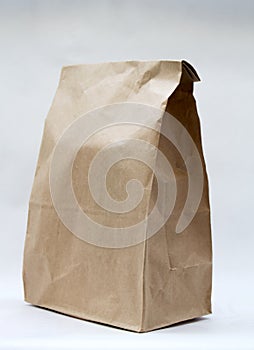 Realistic brown paper bag on white background