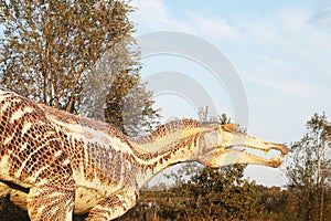 Realistic copy of spinosaur in a natural environment