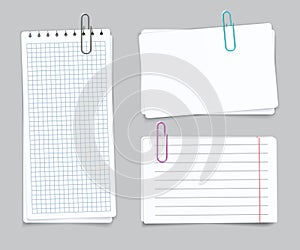 Realistic Different sheets. Blank gridded notebook paper color paper clips. Vector notepapers