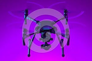 Realistic Drone Quadcopter With Camera Isolated On Bright Violet Background. Modern Videography. 3d rendering